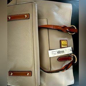 Dooney and Bourne pocket book retails 278.00  . check Description on measurement